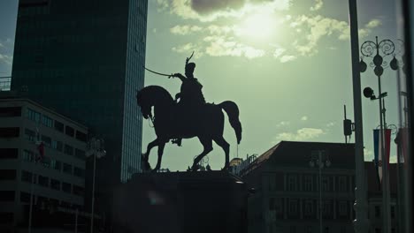 silhouette of the iconic equestrian statue of josip jelačić against the sunlit sky in zagreb’s main square