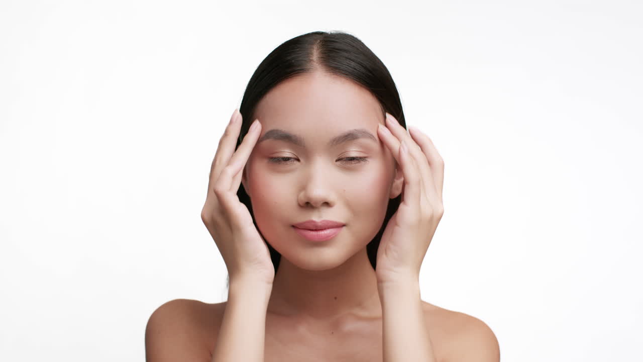 Close-up Portrait of a Young Asian Woman Practicing Skincare