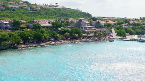 line of buoys surround karakter beach in curacao on tropical sunny day