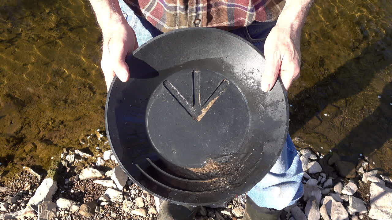 Gold collects in prospector's gold pan