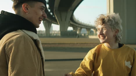 Cheerful-Male-and-Female-Friends-Meeting-on-Street