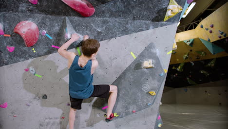 boy bouldering in a gym