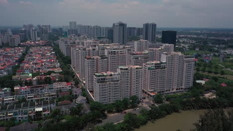 aerial suburban view on sunny day with large apartment and housing development on river-1