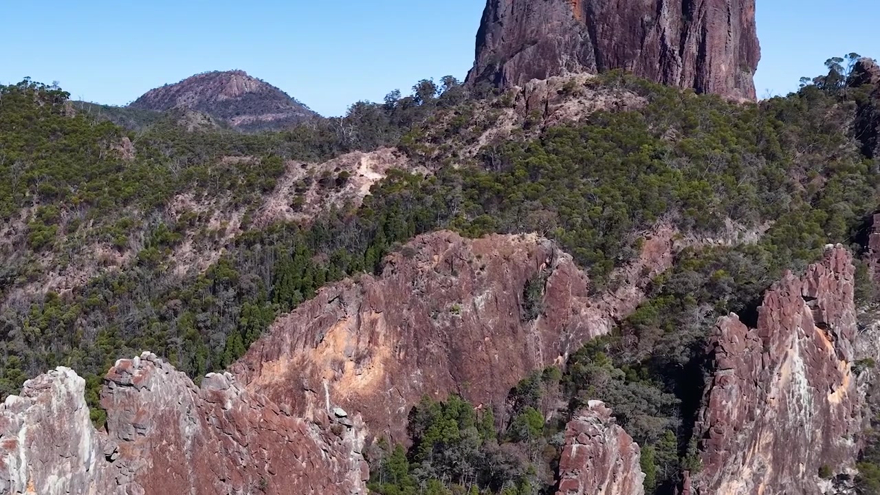 Ampia veduta della formazione rocciosa The Breadknife sotto cieli azzurri e sereni nel Parco Nazionale Warrumbungle.