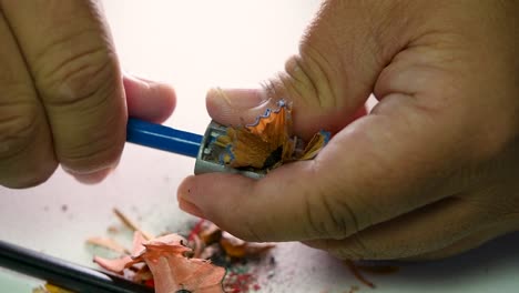 Footage-of-hands-slowly-sharpening-a-pencil-and-some-coloured-pencils-with-a-Wedge-Pencil-Sharpener