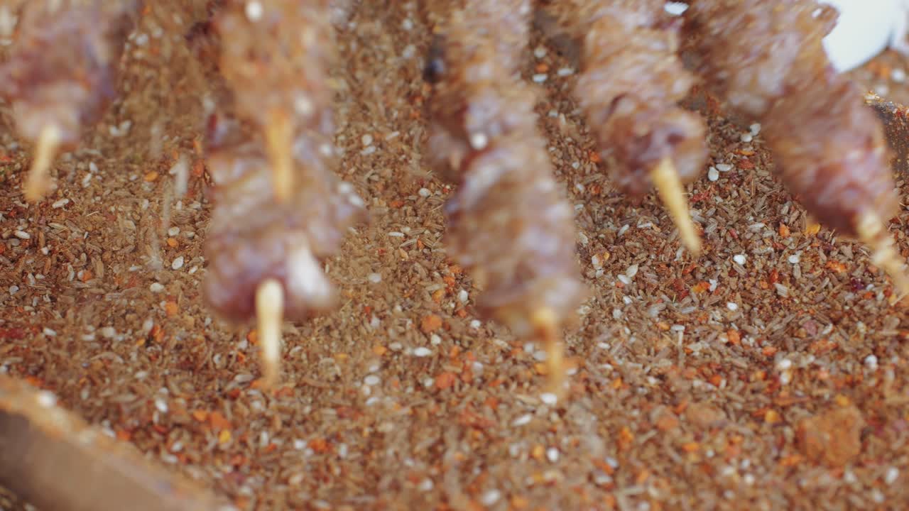 Kebab in Mix spices dried pink, black pepper, green dill, red paprika, yellow turmeric, garlic, salt close-up macro. A bunch of natural spice for food .Seasonings and condiments concept