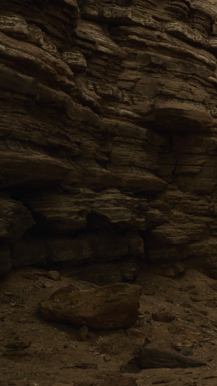 Rock formations stand tall under the soft dusk light in a remote canyon area