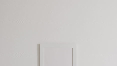 white frame with copy space on white background against white wall