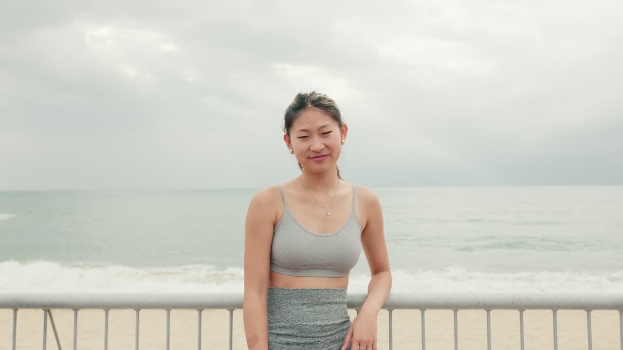 Fit Asian Woman Smiling After Beach Workout