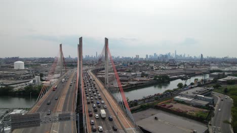 Congestion-on-the-Brooklyn-Queens-Expressway-with-NYC-skyline-in-the-distance,-cloudy-gray-day