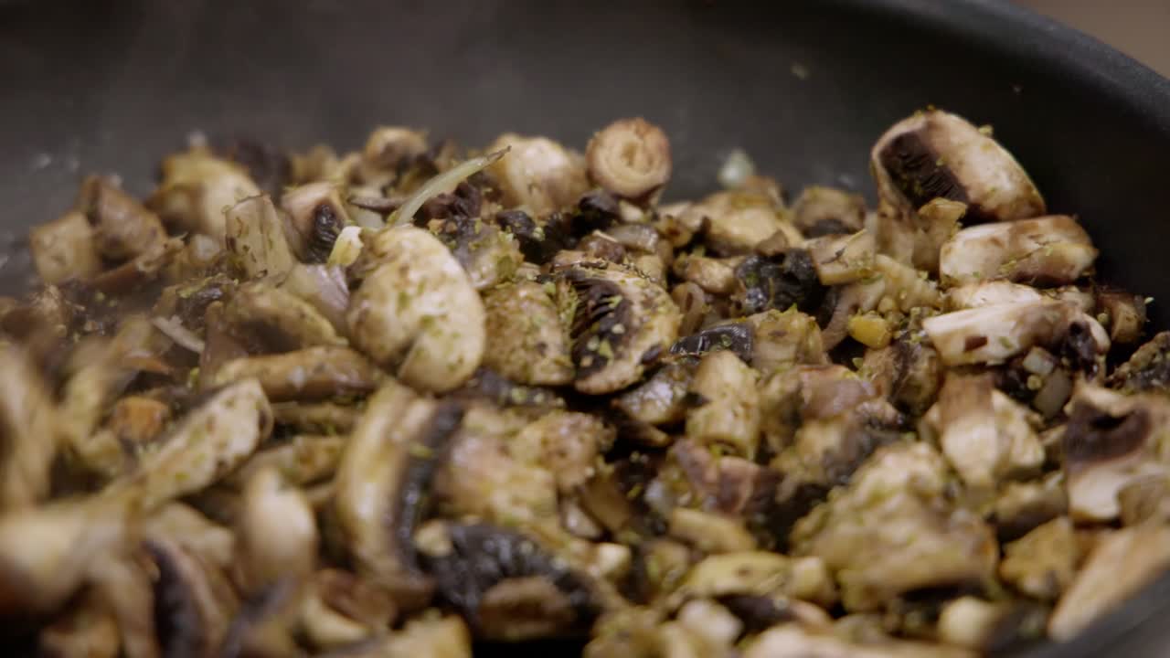 -Cooking mushrooms in a pan -Close-up -29,97 Fps -Shot on Canon R5C