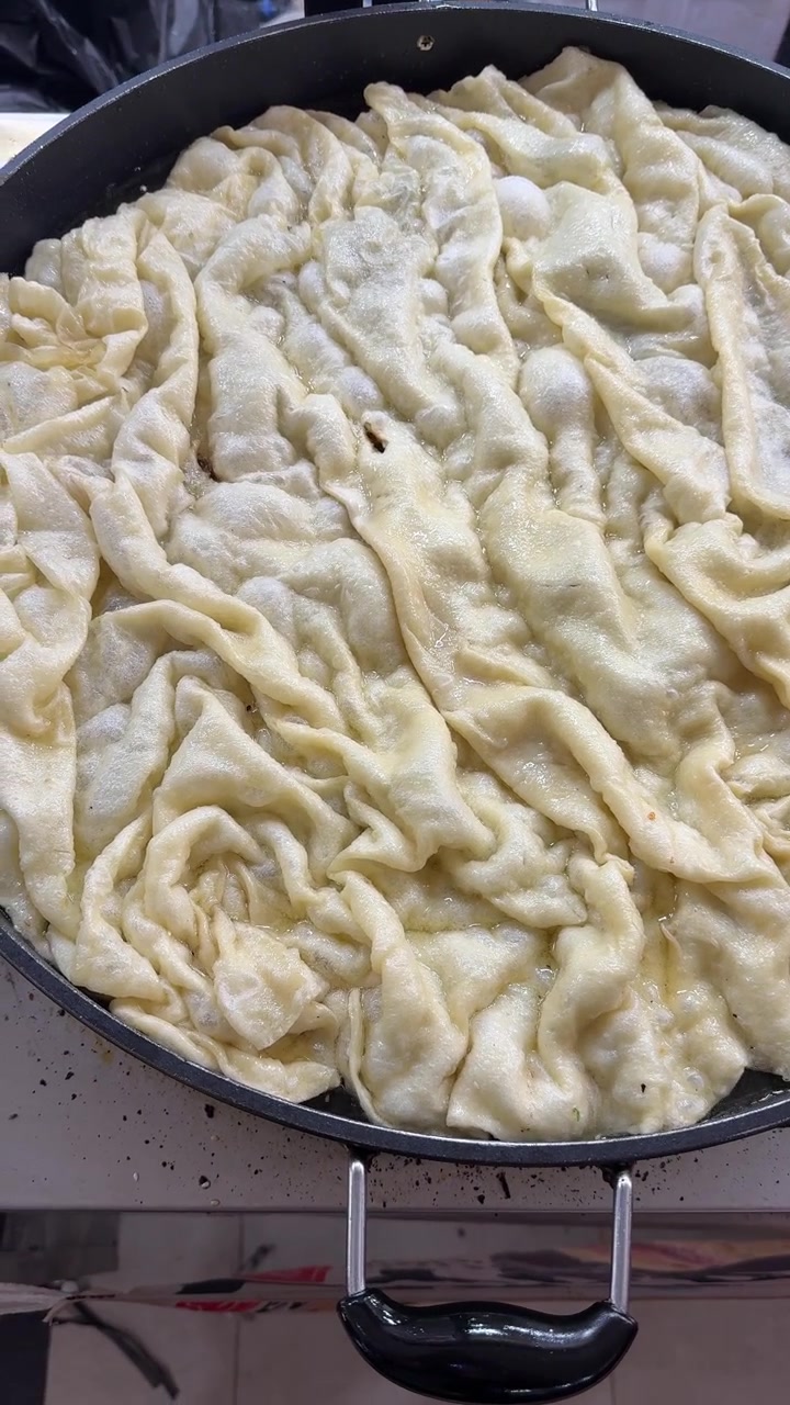 Traditional Flatbread Cooking in a Large Frying Pan