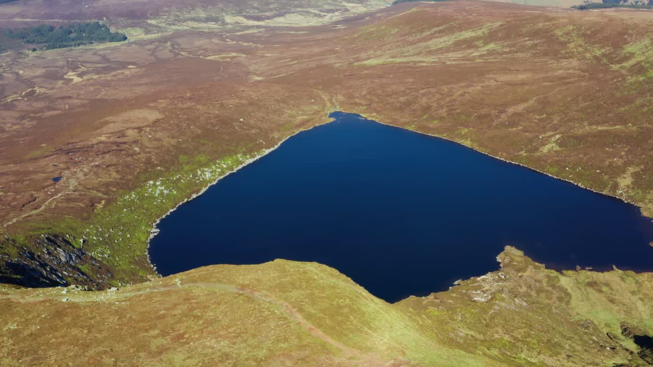 Aerial Orbit Shot of Lough Ouler, Wicklow’s Iconic Heart Shaped Mountain Lake on a Sunny Day