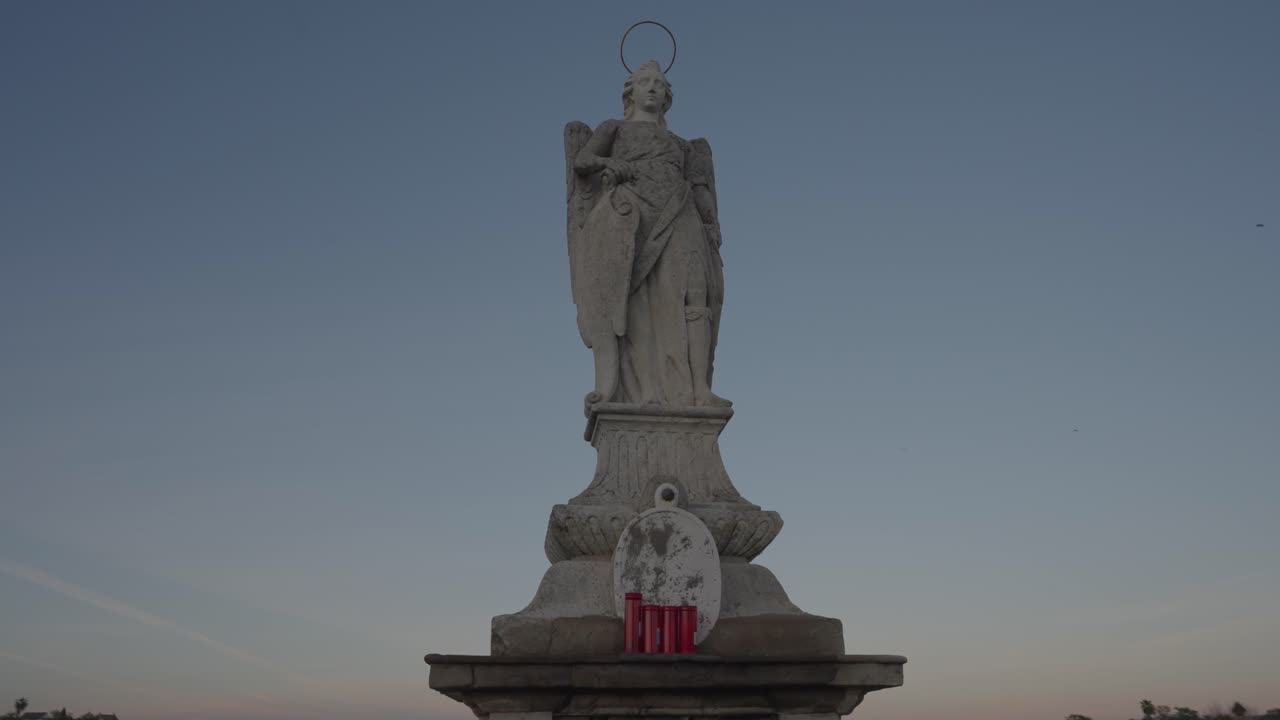 Angel statue against a blue sky