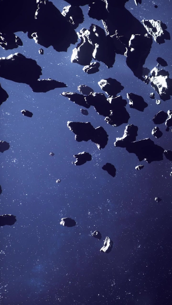Asteroid field floating in space with stars visible in the dark sky