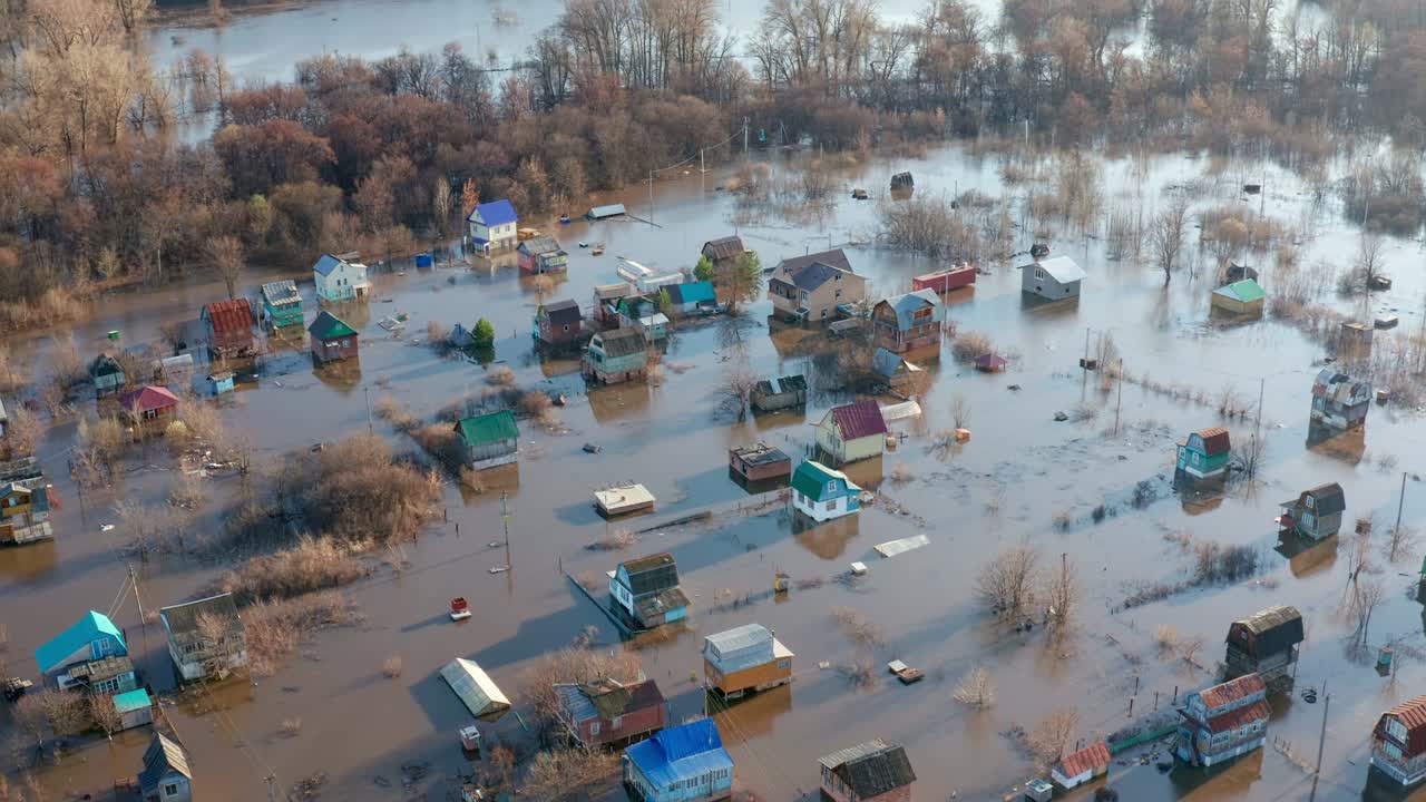 The Concept of disaster prediction. The rays of the setting sun illuminate the flooded village. Drone footage.