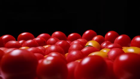 a breathtaking closeup shot of luscious cherry tomatoes showcasing their vibrant colors against a a breathtaking closeup shot of luscious cherry tomatoes showcasing their vibrant colors against a dark backdrop