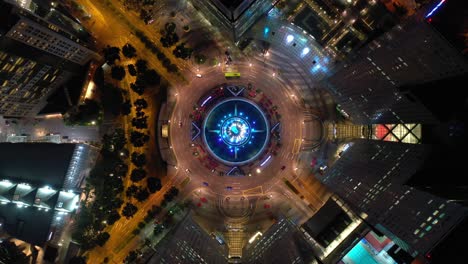 night illumination flight over singapore city famous downtown traffic circle aerial topdown panorama 4k