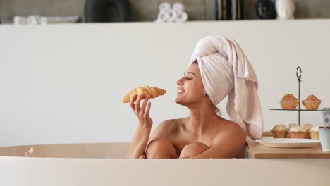 woman enjoying breakfast in a bathtub