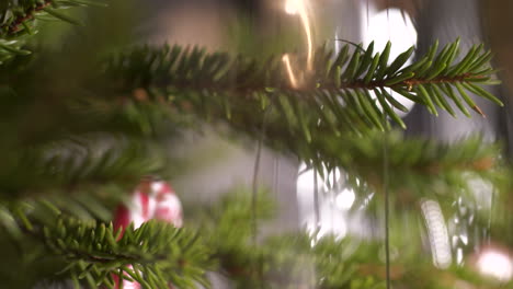 christmas tree with first christmas child toy to celebrate in tilt close up shot