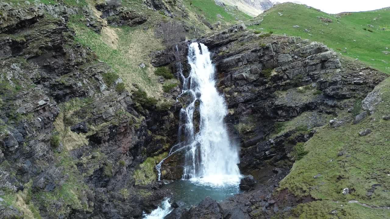 Waterfall flowing over rocky terrain in Valle de Izas, Aragón, Spain, peaceful nature scene
