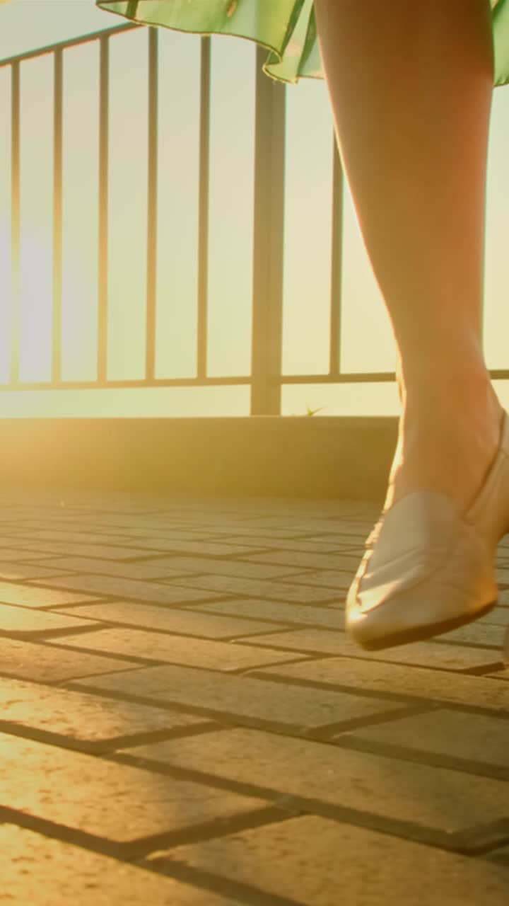 Woman Walking on a Balcony at Sunset