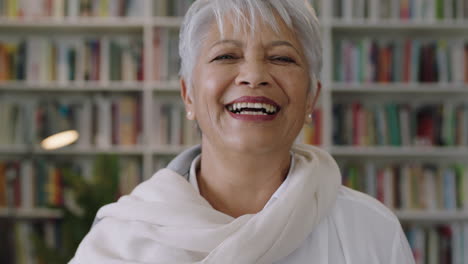 portrait-of-friendly-indian-middle-aged--teacher-laughing-standing-in-library