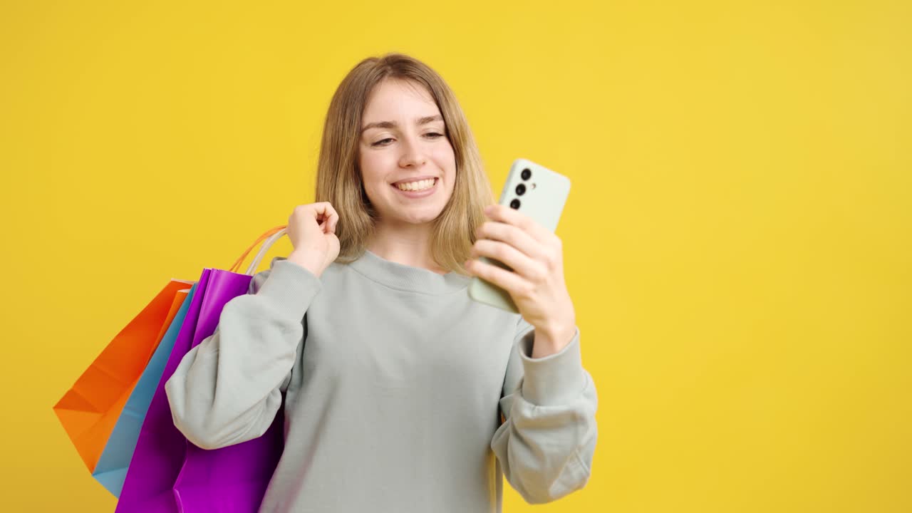 Happy shopper checking smartphone app after successful purchase