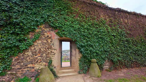 Walking-through-narrow-doors-and-revealing-Prague-panorama,-POV