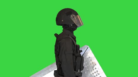 riot police special forces unit standing with the shield down on a green screen, chroma key