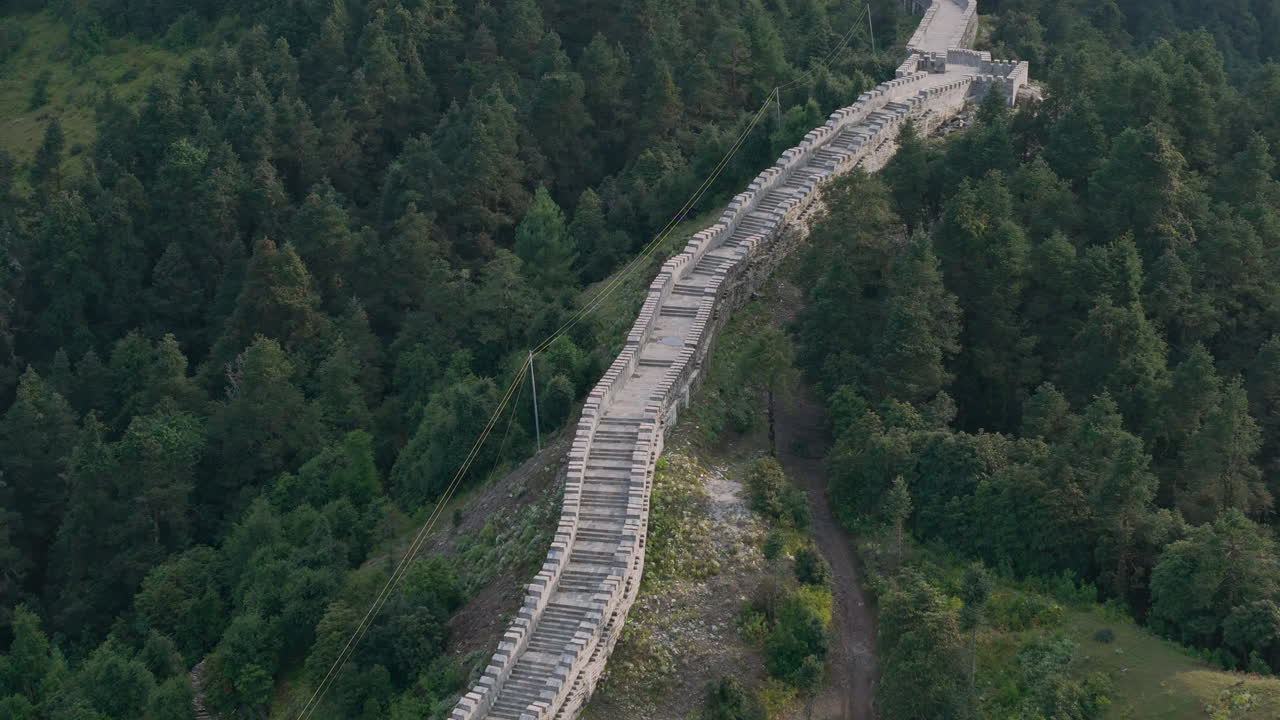 Aerial View of the Great Wall of China Winding Through a Lush Forest