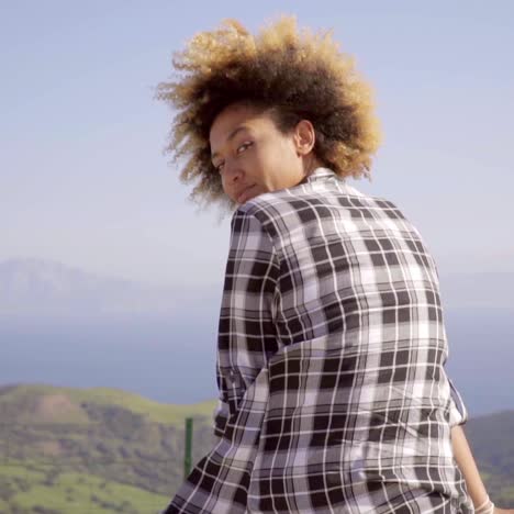 woman enjoying view of ocean and mountains