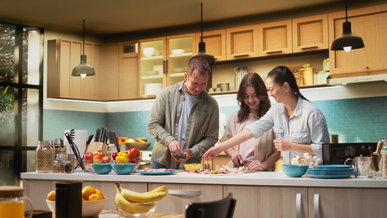 Smiling little family enjoying pizza day and cooking together in the kitchen