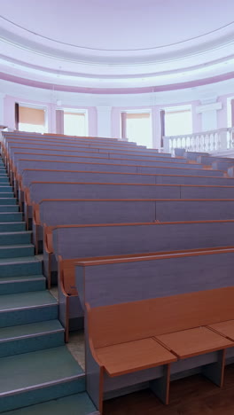 wooden panelled university lecture theatre. classroom with wooden furniture without student. vertical video