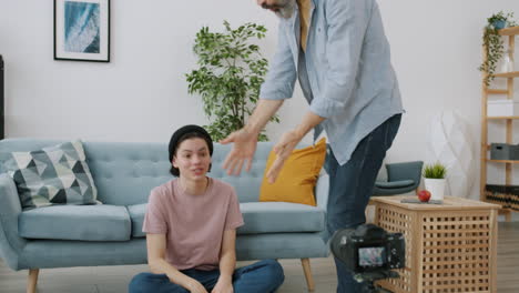 teenager and adult having a conversation in front of a camera