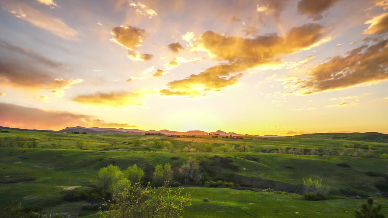 Sun setting over rolling green hills in Southern Colorado. Amazing colors.