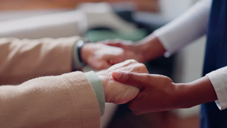 nurse holding hands with a senior patient