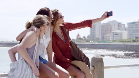 Teenage-girls-taking-selfie-at-beach-on-summer-vacation--close-up