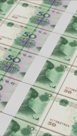 vertical video of 50 chinese renminbi banknotes printing by a money press