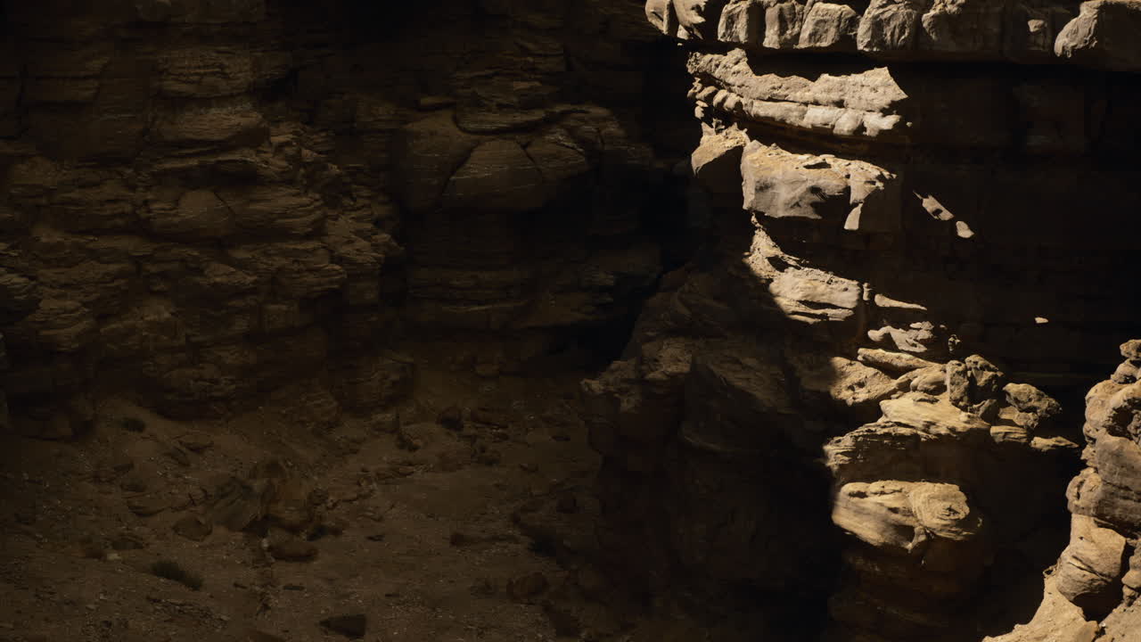 Exploring rocky terrain in a deep canyon with natural formations at dusk