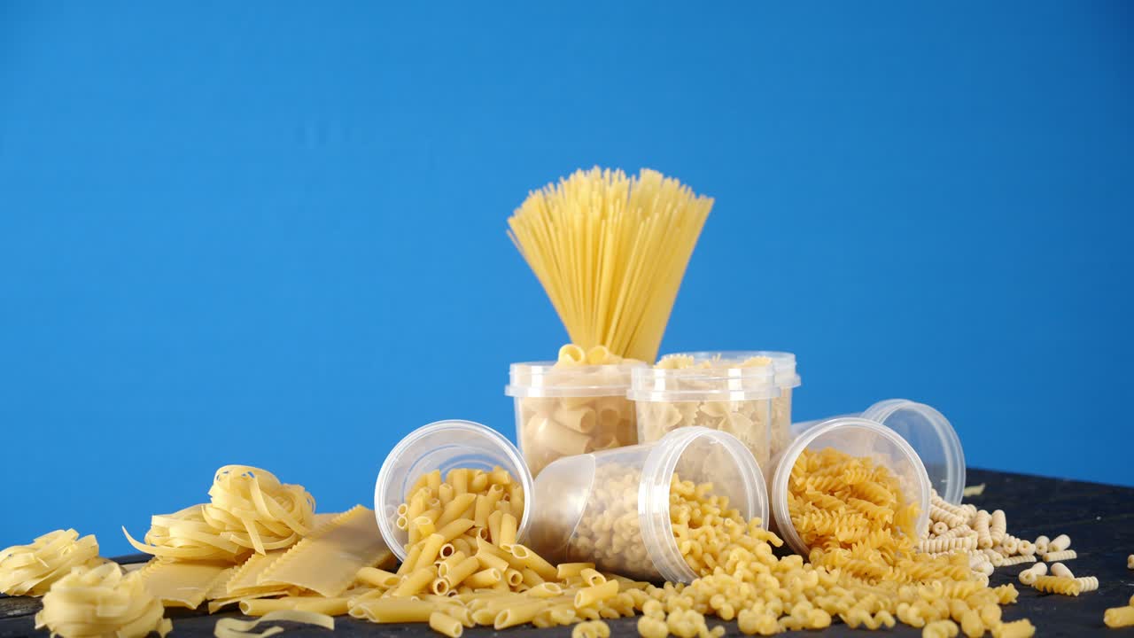 A variety of types of pasta dry on the table slowly rotates.