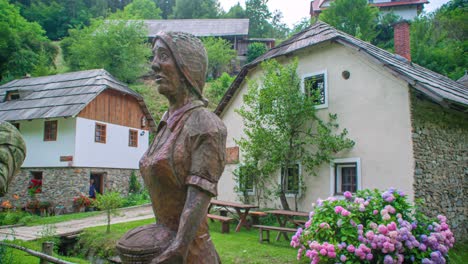 carved wooden sculptures in the gardens of polhov mill, slovenia