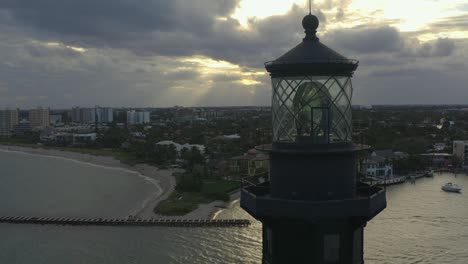 Aerial-orbiting-a-lighthouse-along-the-ocean-and-surrounding-area-in-Florida