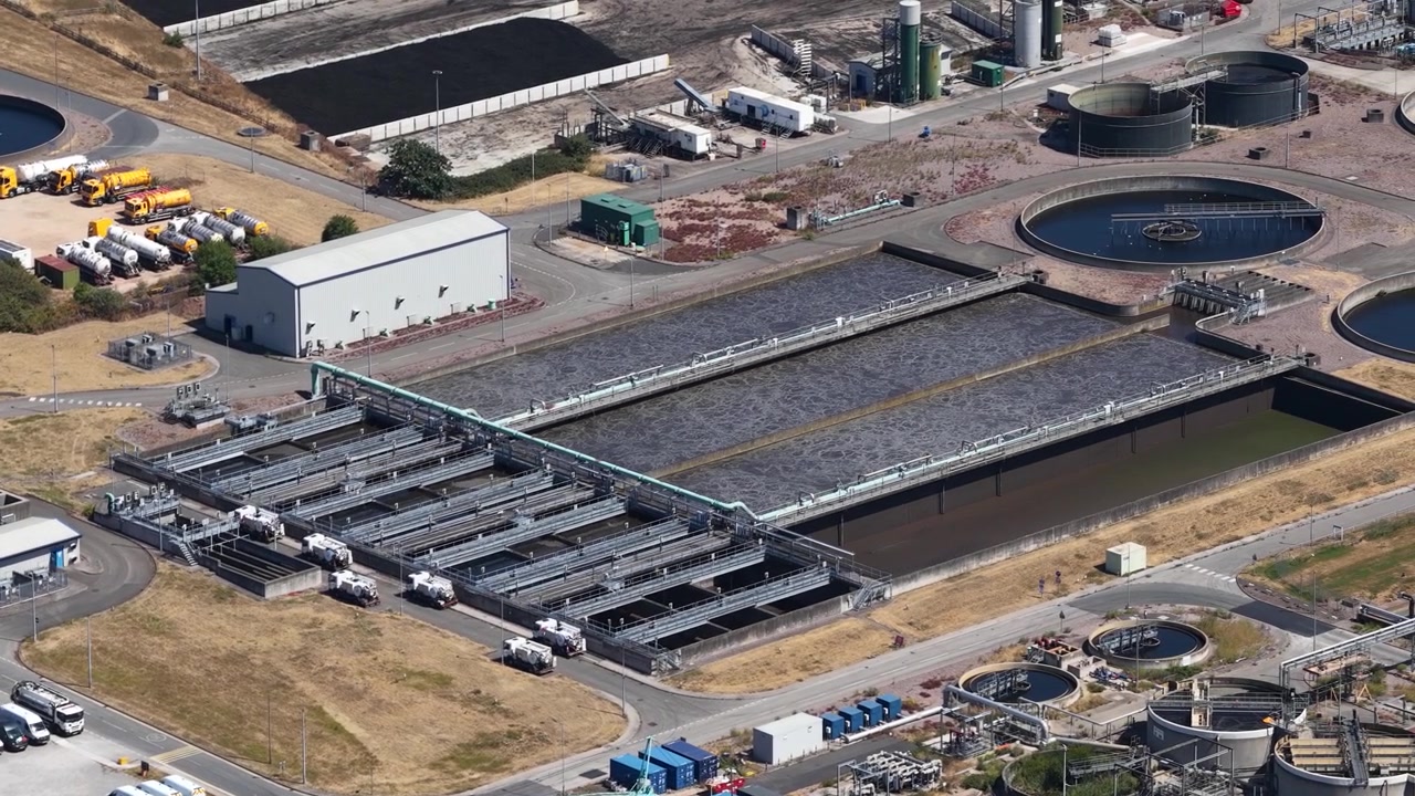 Aerial view of a wastewater treatment plant with settling tanks, filtration and biological processing used to clean sewage and safely discharge or reuse treated water.