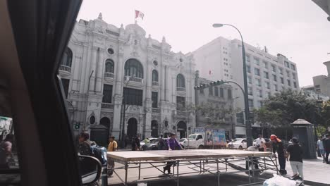 person's pov from a car traveling through the street of downtown lima, peru.