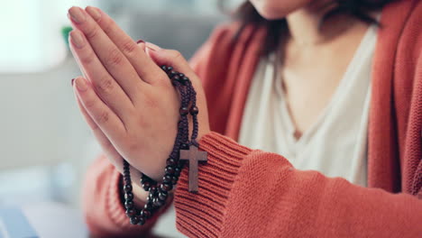 Christian-woman,-rosary-and-hands-praying-in-home