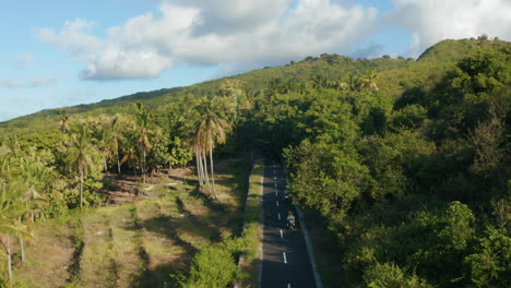 aerial footage of people is driving the motorbike in nusa penida island