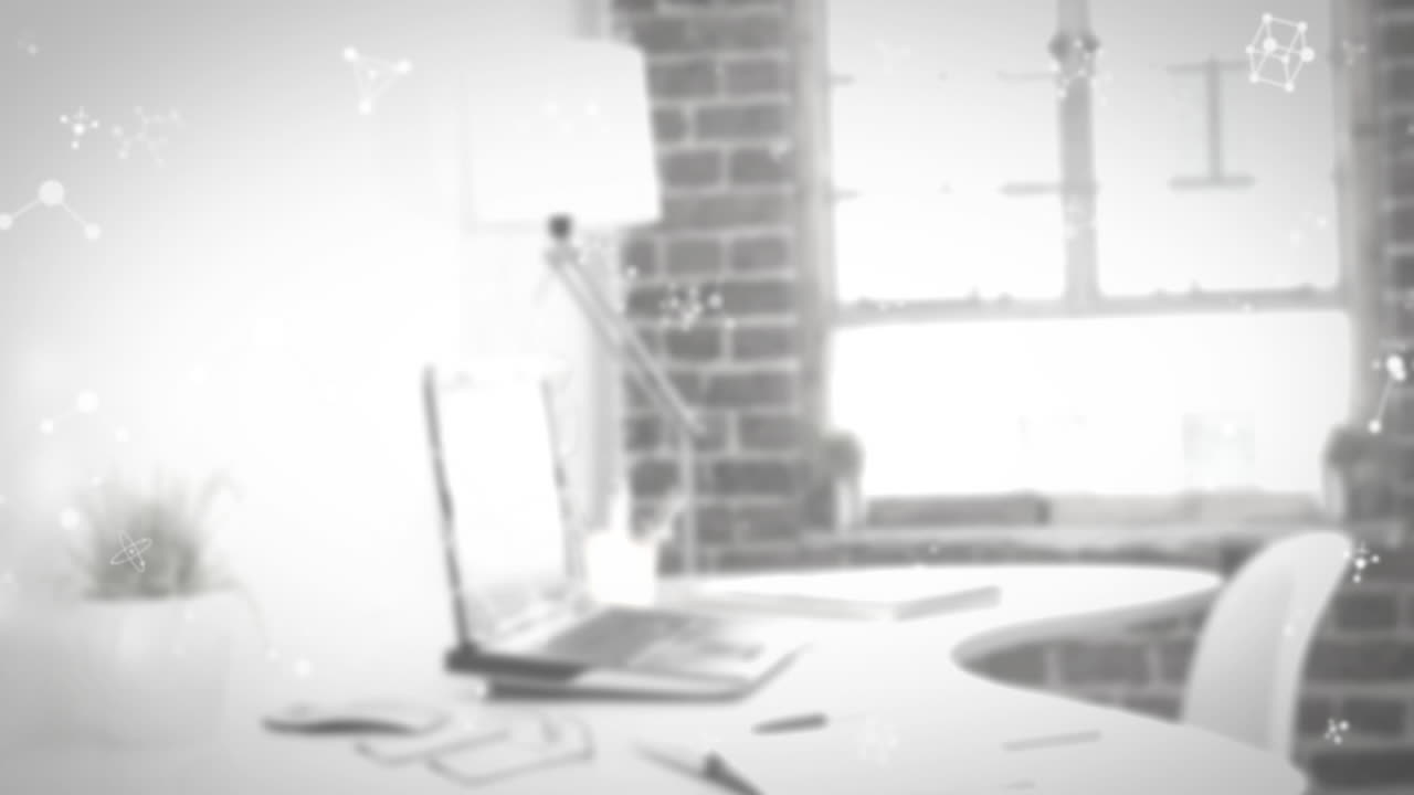 책상 위의 노트북에 움직이는 분자의 애니메이션