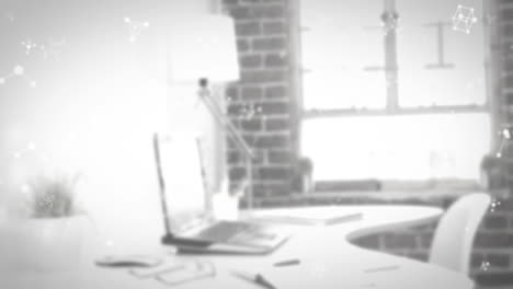 animación de moléculas que se mueven sobre el portátil en el escritorio