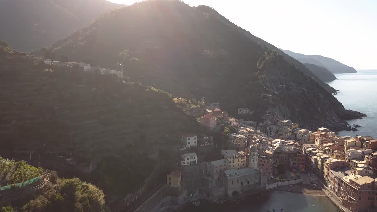 droneshot flying backwards away from italian coastline and village at sunrise 4k.mp4